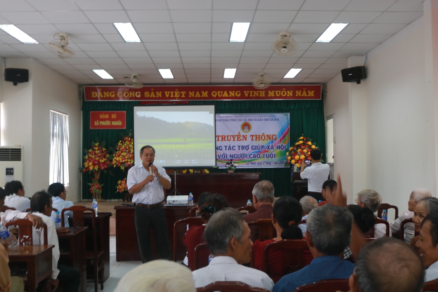 Đồng chí Phan Tuấn Kiệt báo cáo tại buổi truyền thông về Công tác trợ giúp xã hội với người cao tuổi tại xã Phước Nghĩa, huyện Tuy Phước
